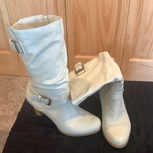 Off white mid calf boots with zipper. Adorned with buckles.